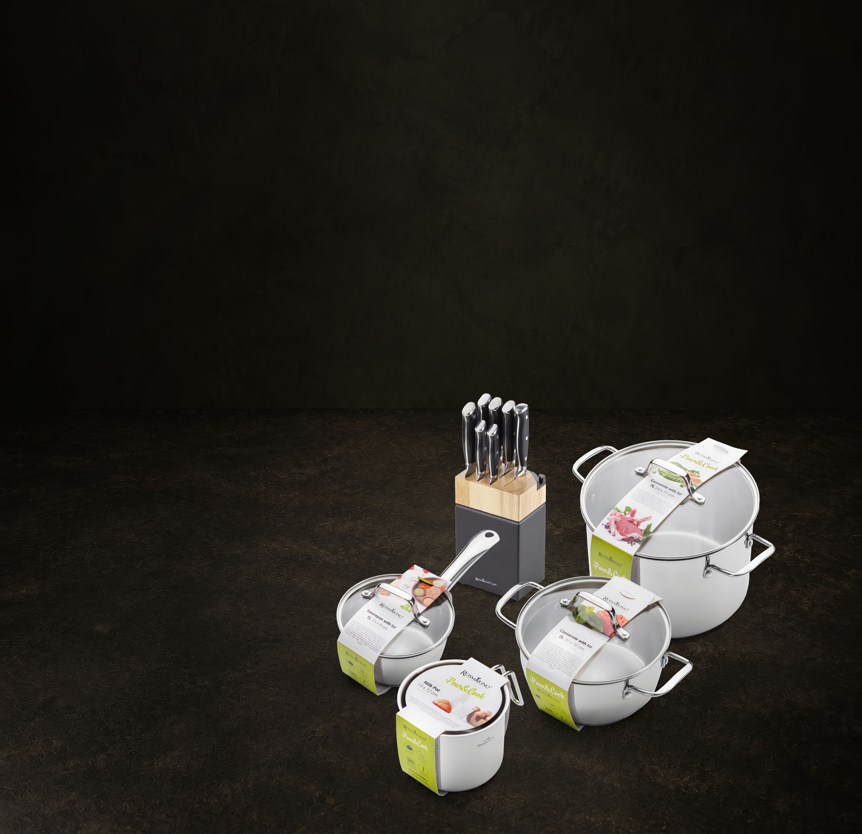 Rosmarino Pour&Cook cookware and Kyoto knife block arranged on a dark stone surface